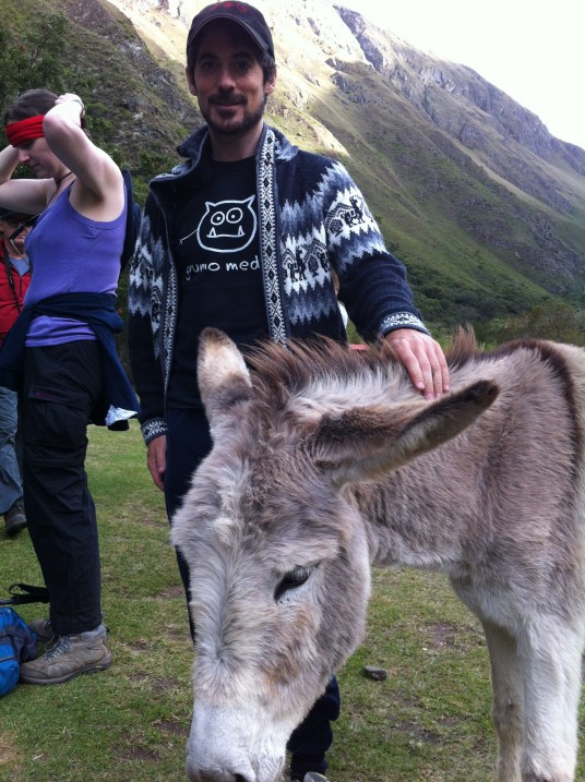 Miguel petting a donkey
