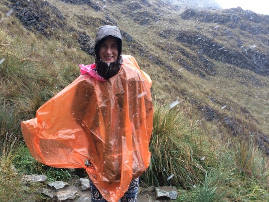 Beth giving a fake smile in the middle of a winter storm - Inca Trail right after Dead Woman's Pass