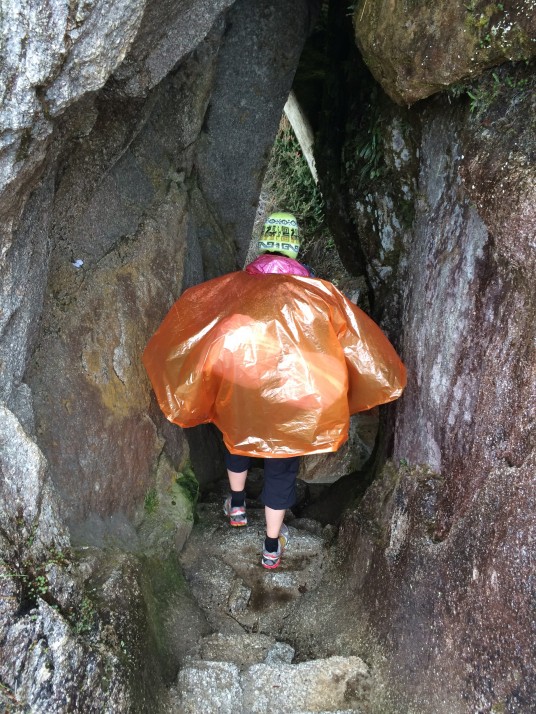Poncho woman down a Inca tunnel