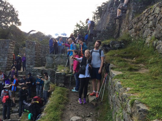 Hikers gather at the Sun Gate where we can first see Machu Picchu
